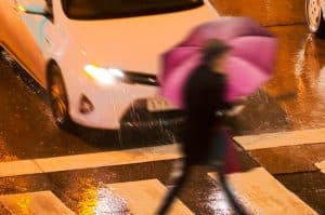 Pedestrian accident cases Pedestrians in dangerous situation in a crosswalk in the city street at night.