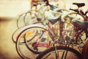 Bicycle accident cases A row of parked bicycles with a focus on one with a basket.